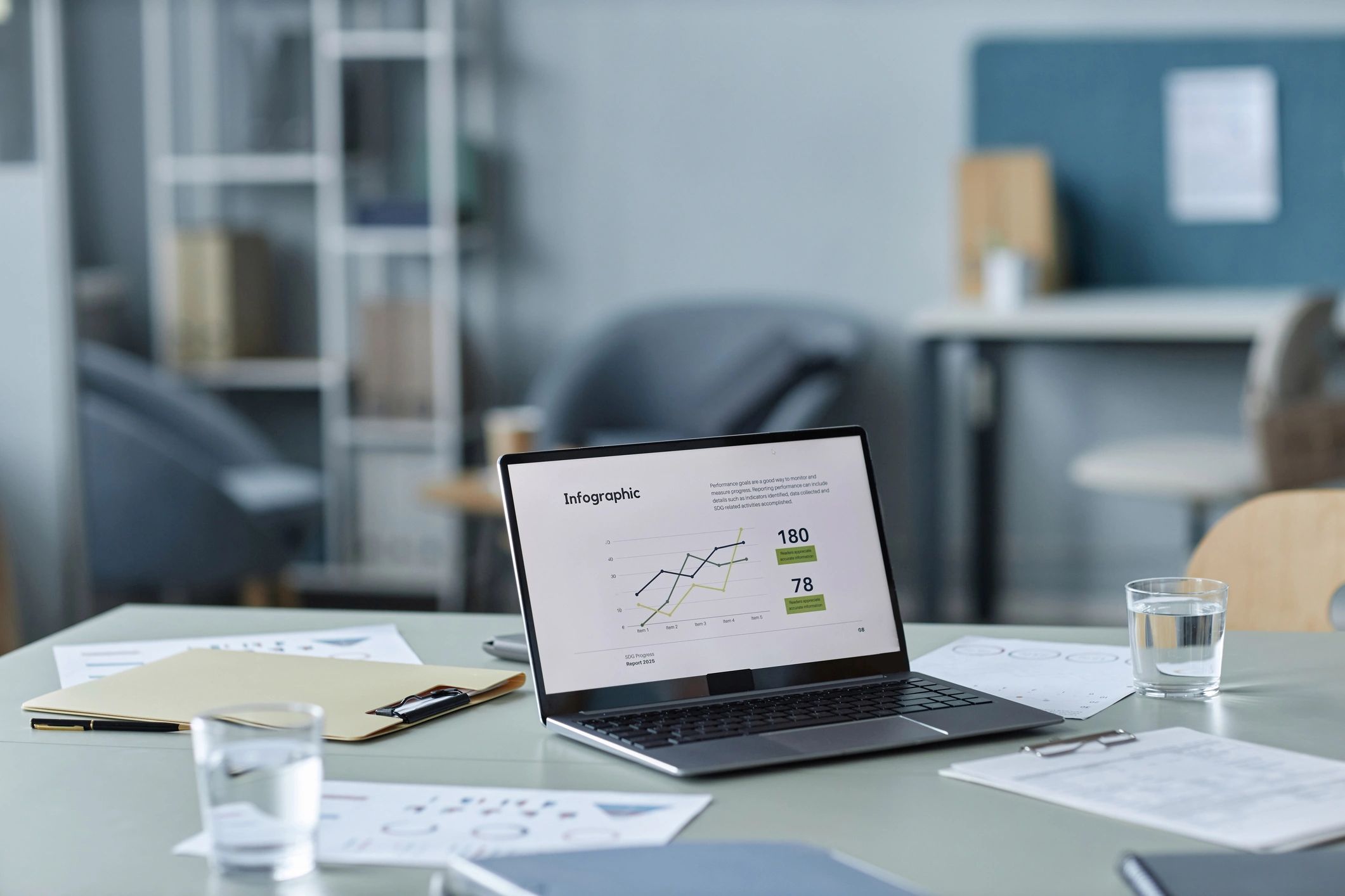 Laptop showing business reports and charts in a modern office
