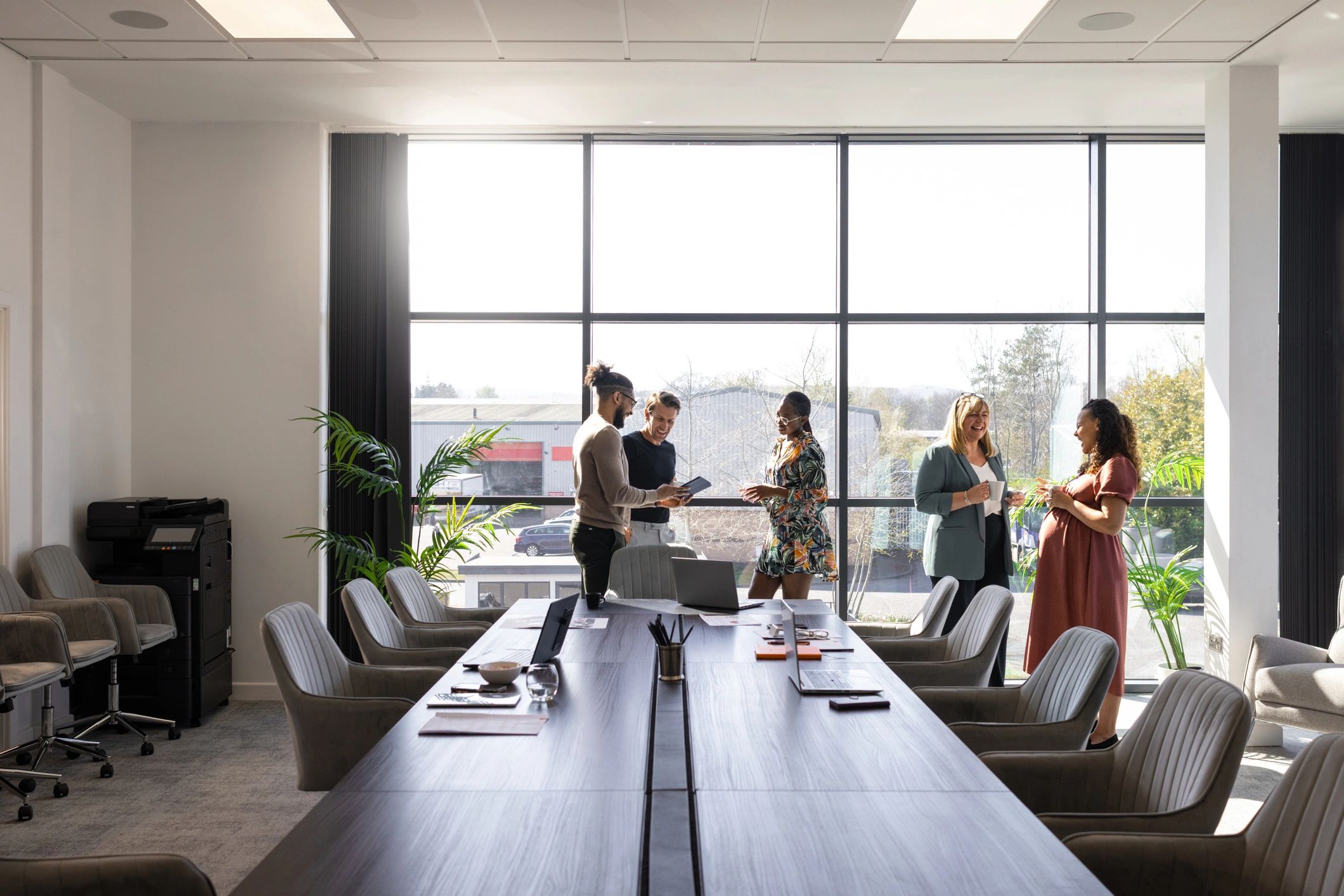 Business colleagues discussing performance in a modern conference room